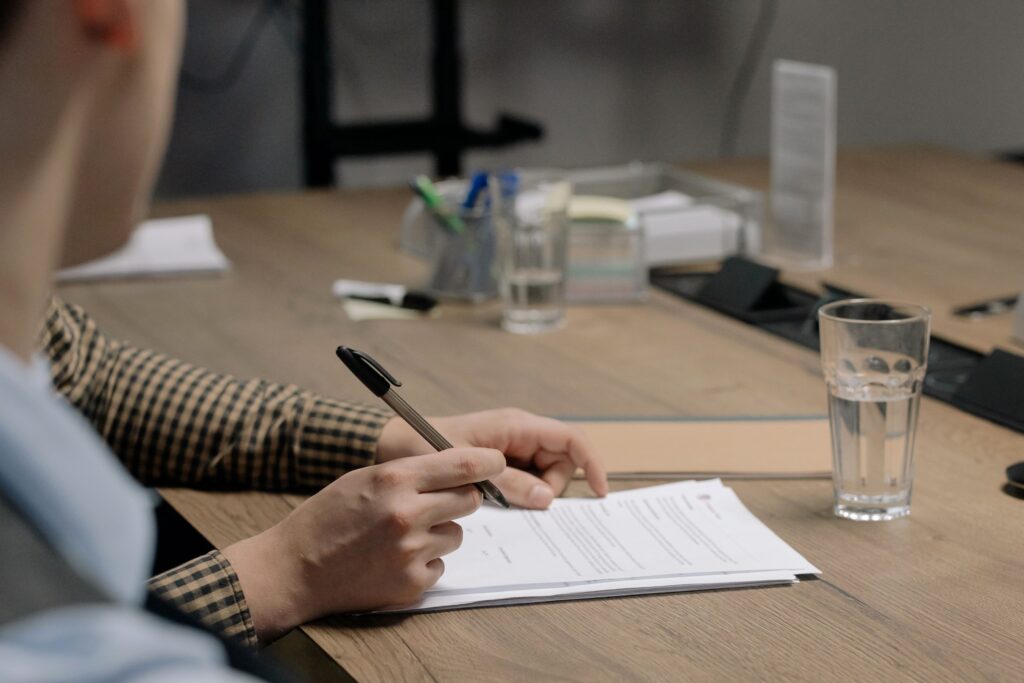 Profissional de RH e gestor analisam documentos do PGR, representando a adequação da empresa à NR-1 e à gestão da saúde mental no trabalho.
